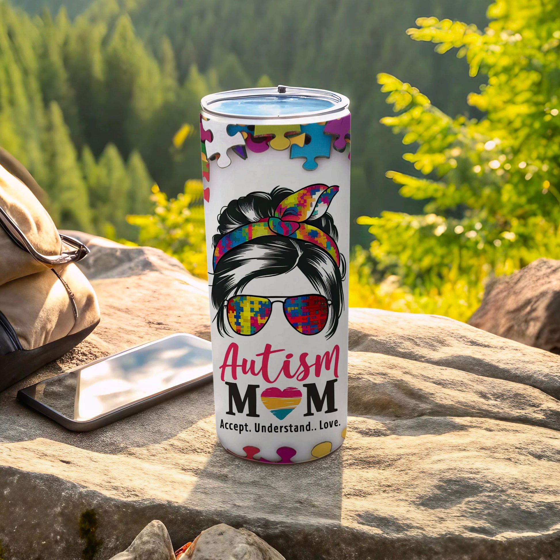Autism Mom tumbler with puzzle pieces, sunglasses, and accept understand love text.