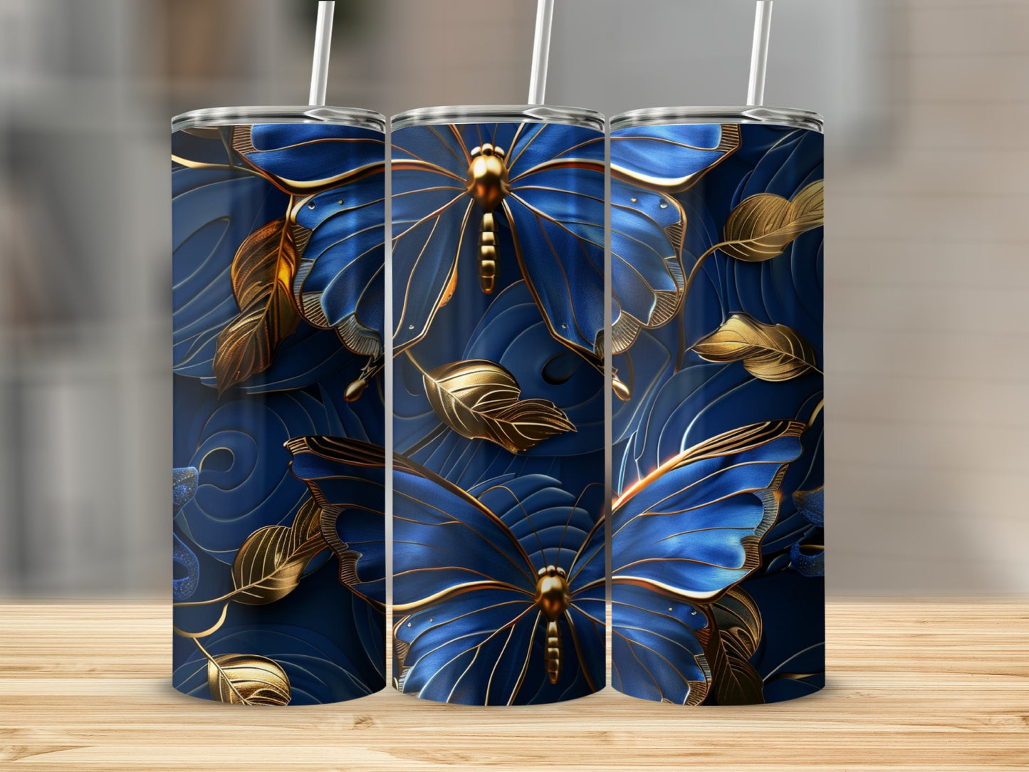 Three blue and gold butterfly tumblers with leaf pattern.