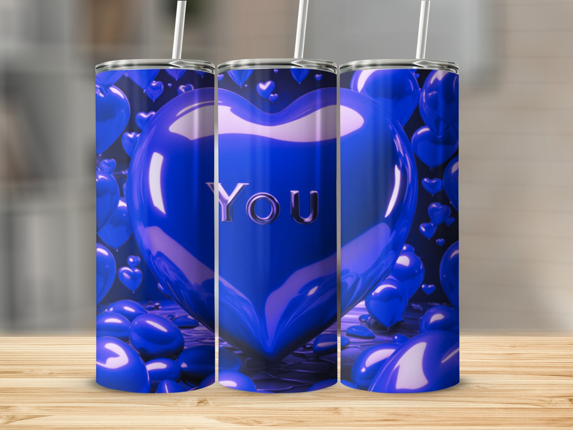 Blue heart tumbler with "YOU" in the center, surrounded by balloons.