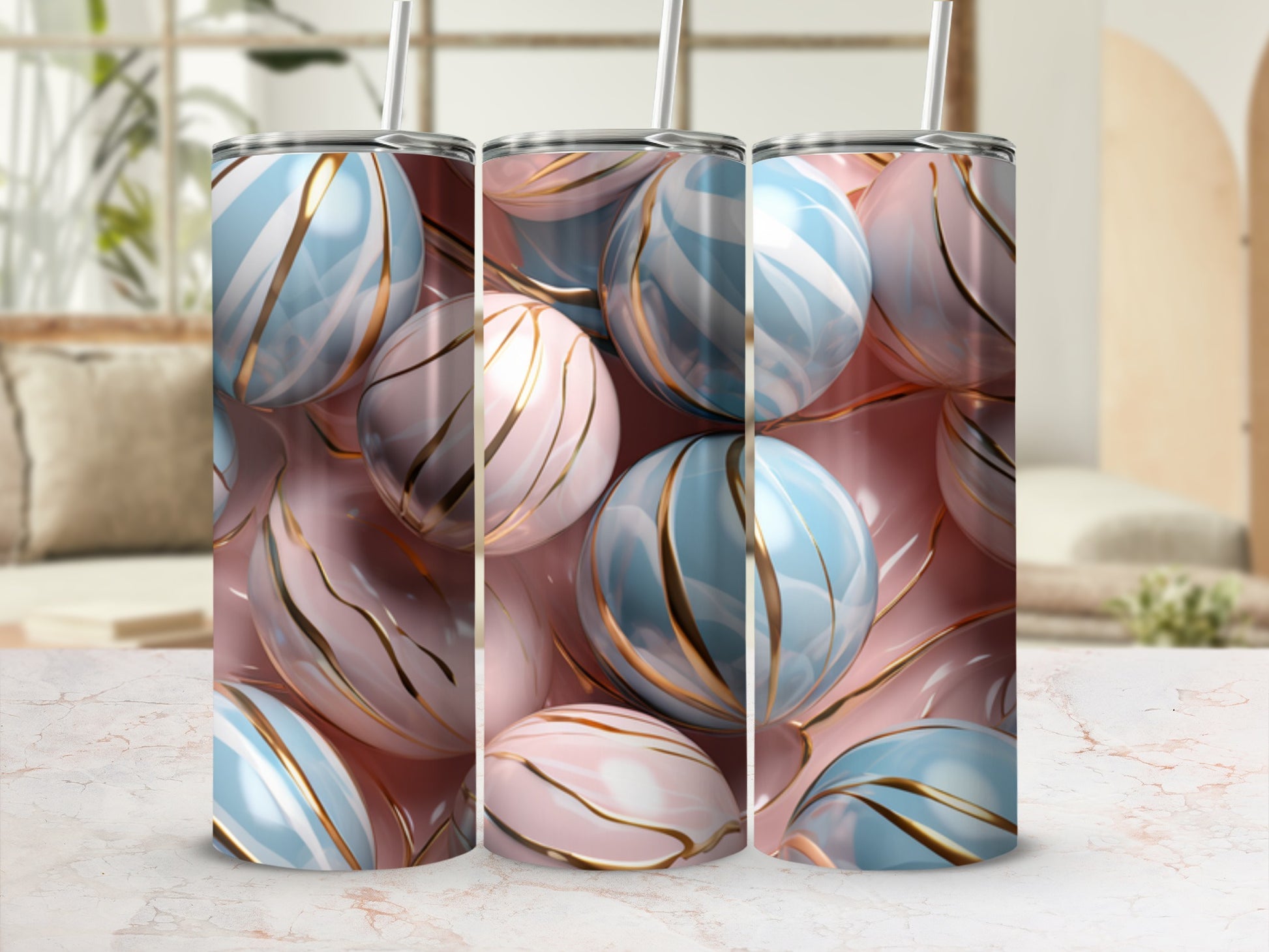 Three tumblers with swirling pink and blue marble patterns and gold accents.