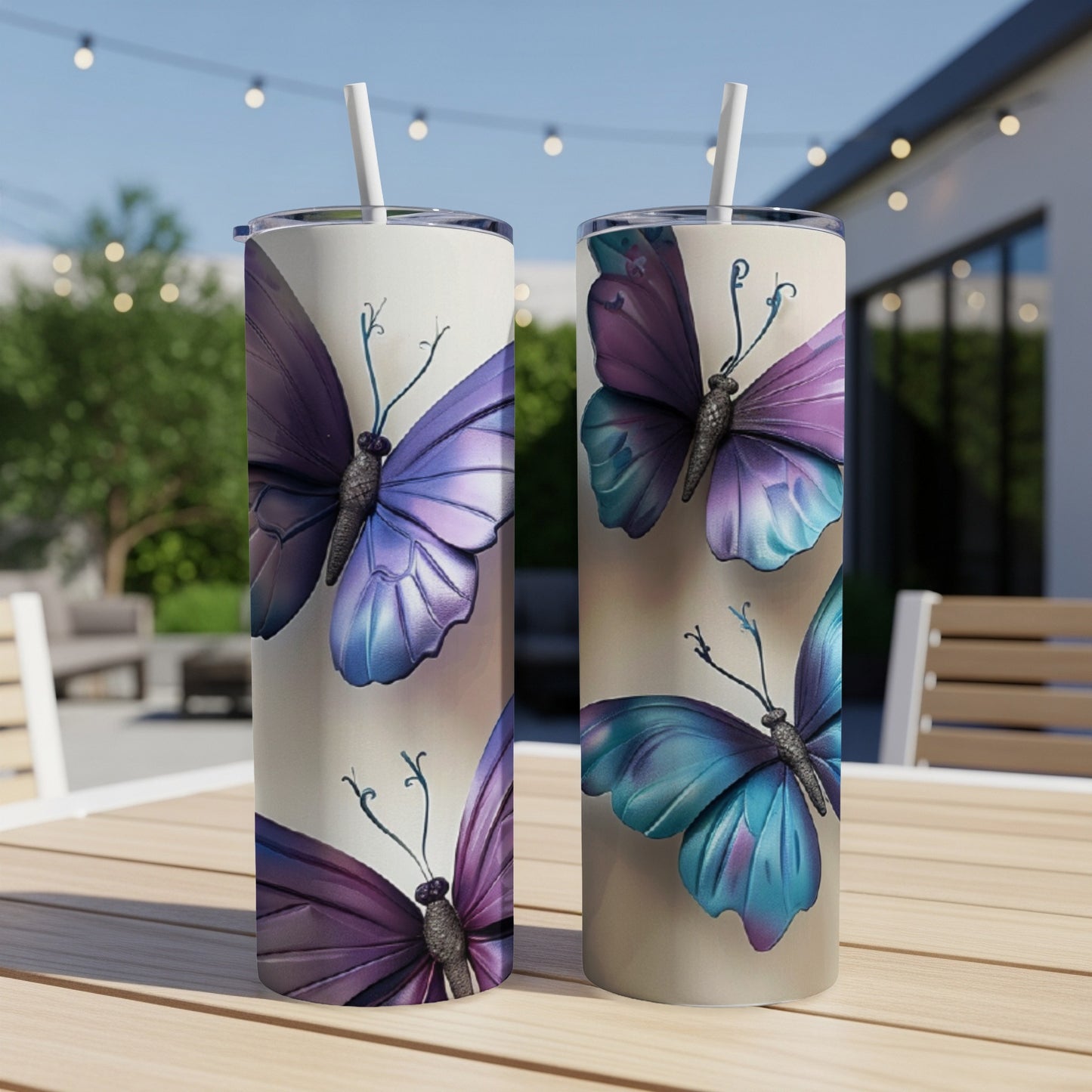 Two tumblers with butterfly designs sit on a table.