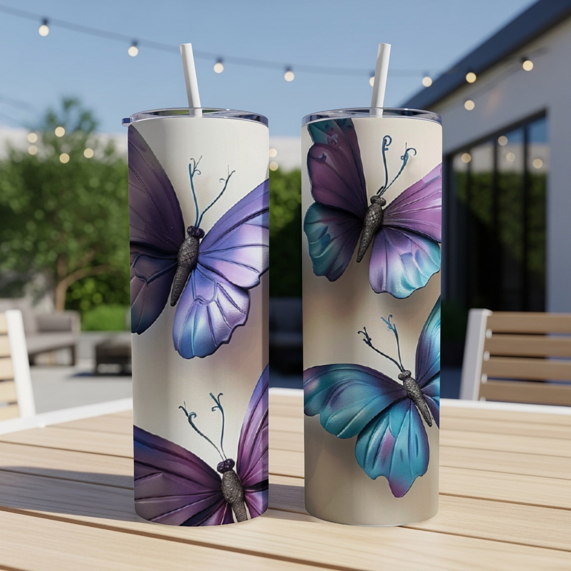 Two tumblers with butterfly designs sit on a table.