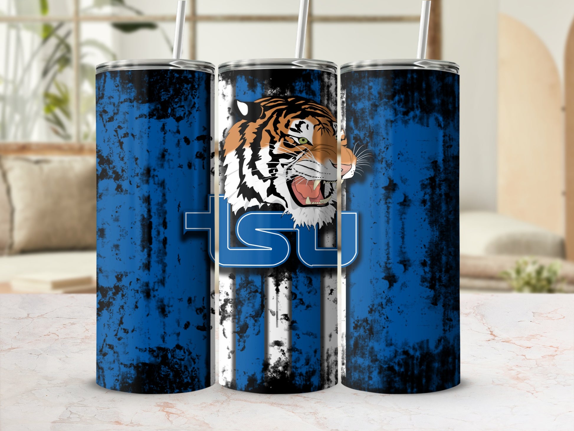 Three tumblers with a snarling tiger head and "TSU" text on a distressed blue and black background.