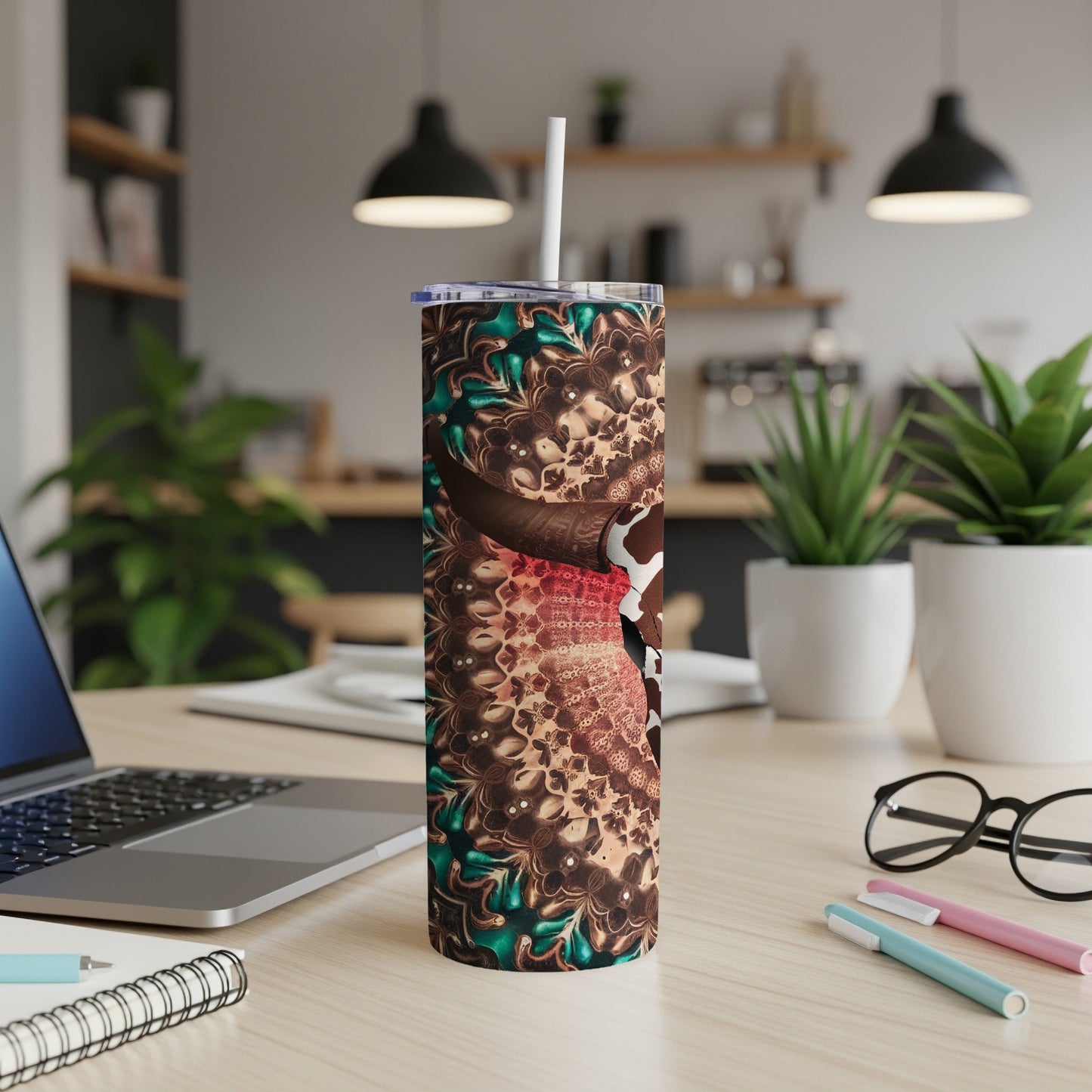Tall tumbler with a mandala pattern and white lid, on a desk.