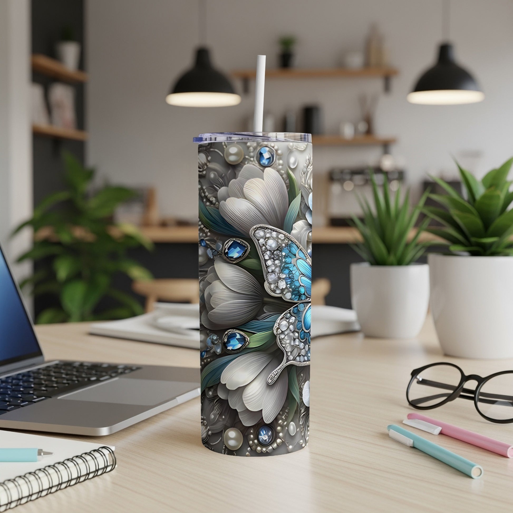 Tumbler with a butterfly and floral design.