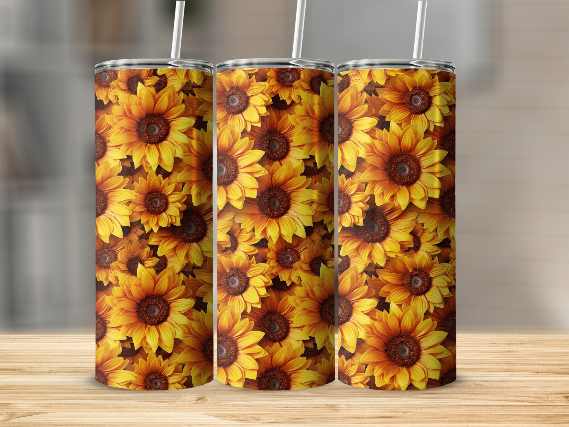 Three tumblers with a repeating sunflower pattern on a wooden surface.