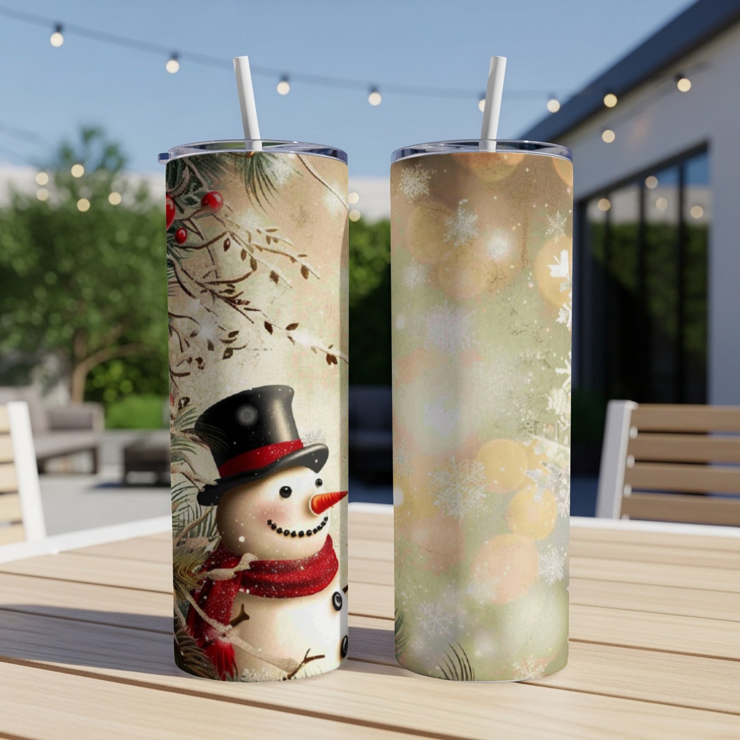 Two tumblers with a snowman design and winter foliage.