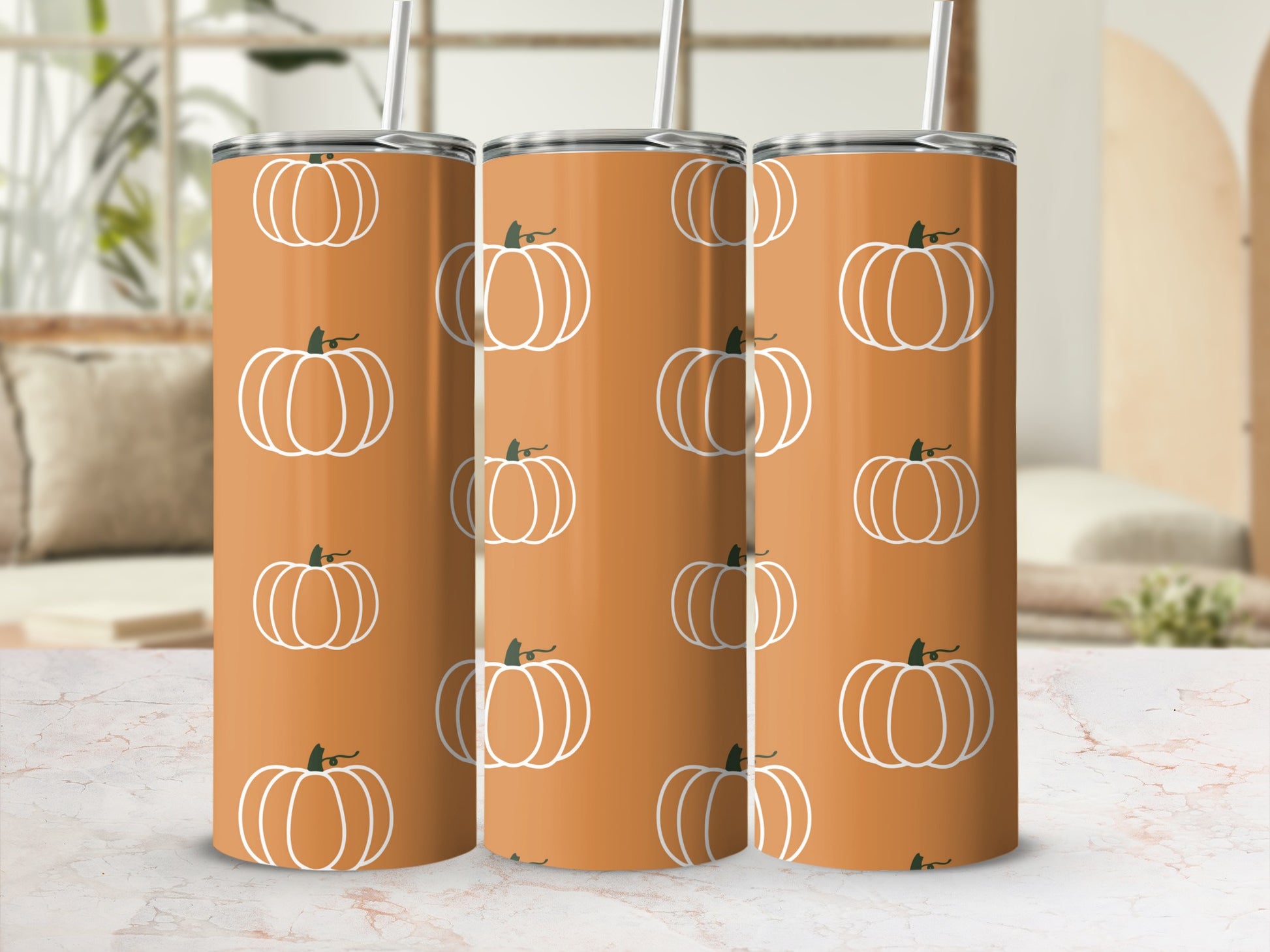 Orange tumbler with white pumpkin pattern, three tumblers visible.