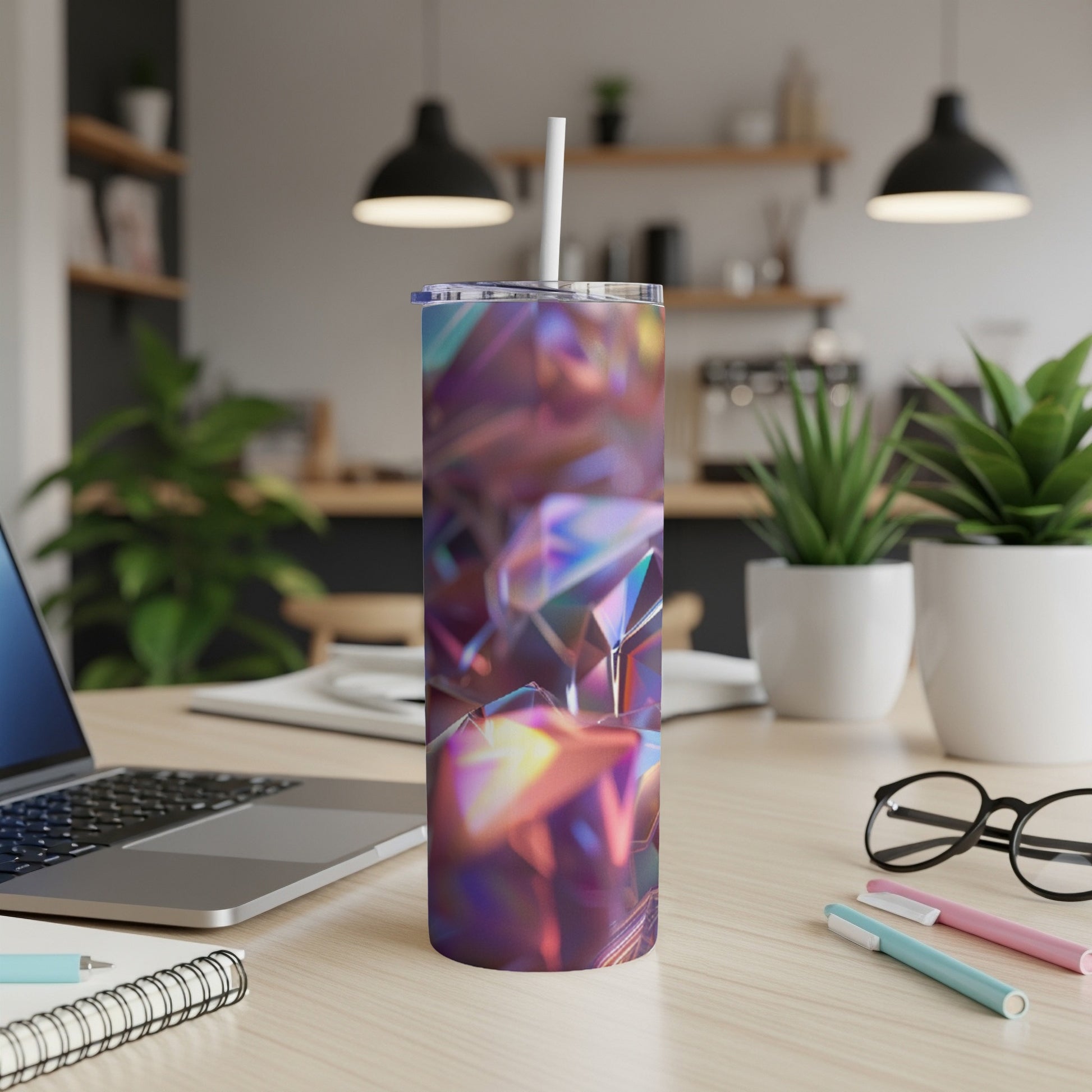 Iridescent geometric tumbler with a white straw on a desk.