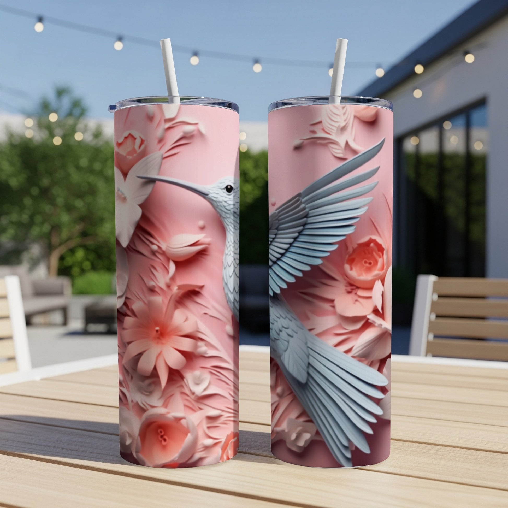 Pink tumbler with hummingbird and floral relief design.