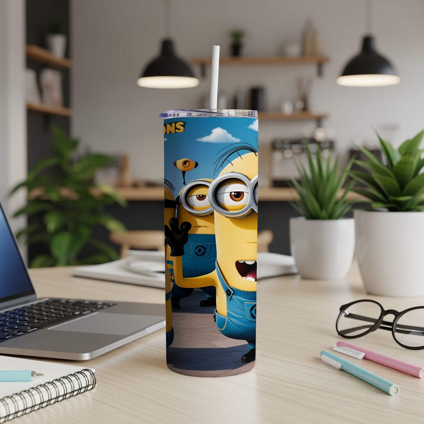 Two Minions characters in denim overalls on a white wooden desk.