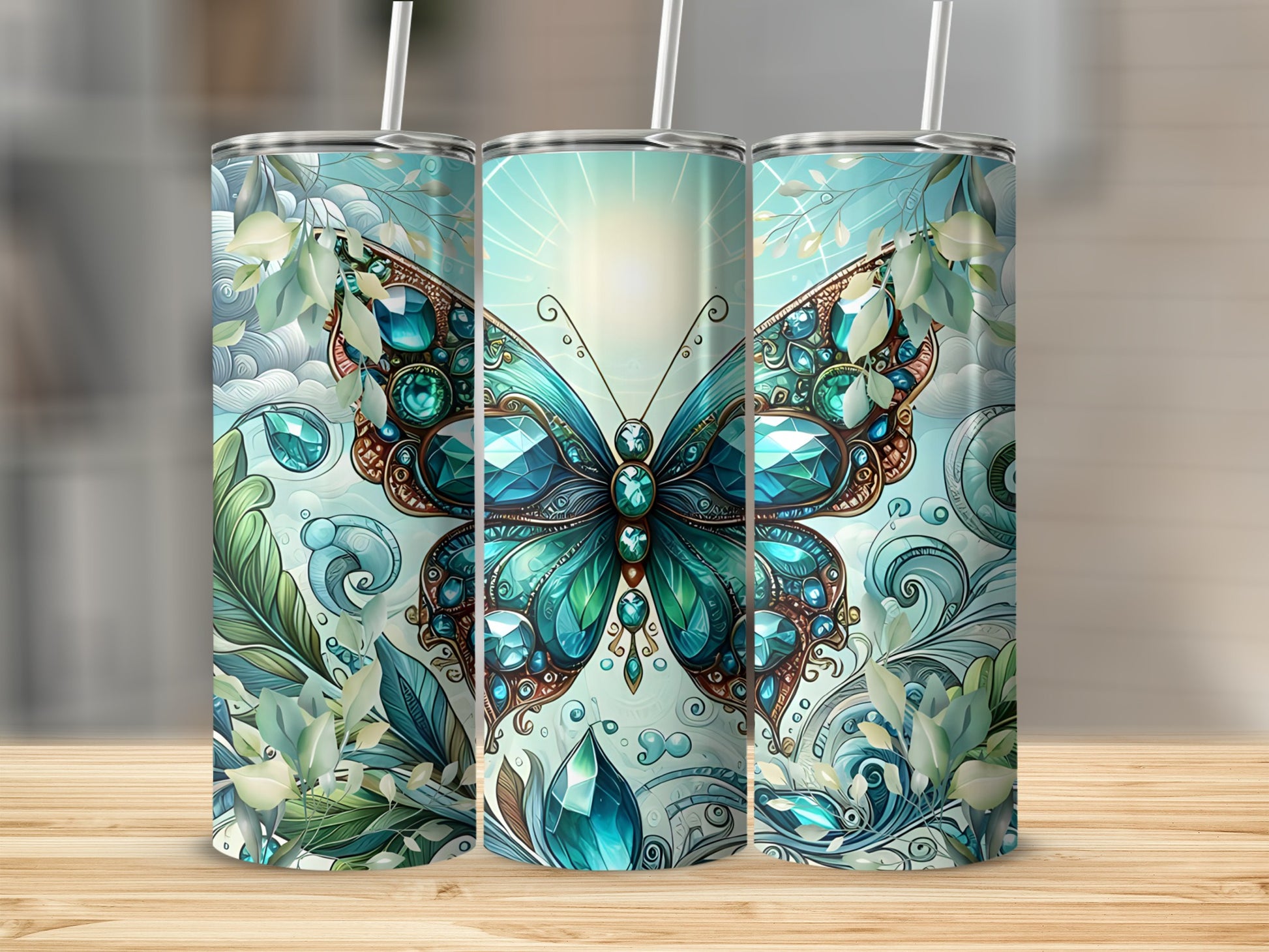 Three tumblers featuring a jeweled butterfly and floral design.