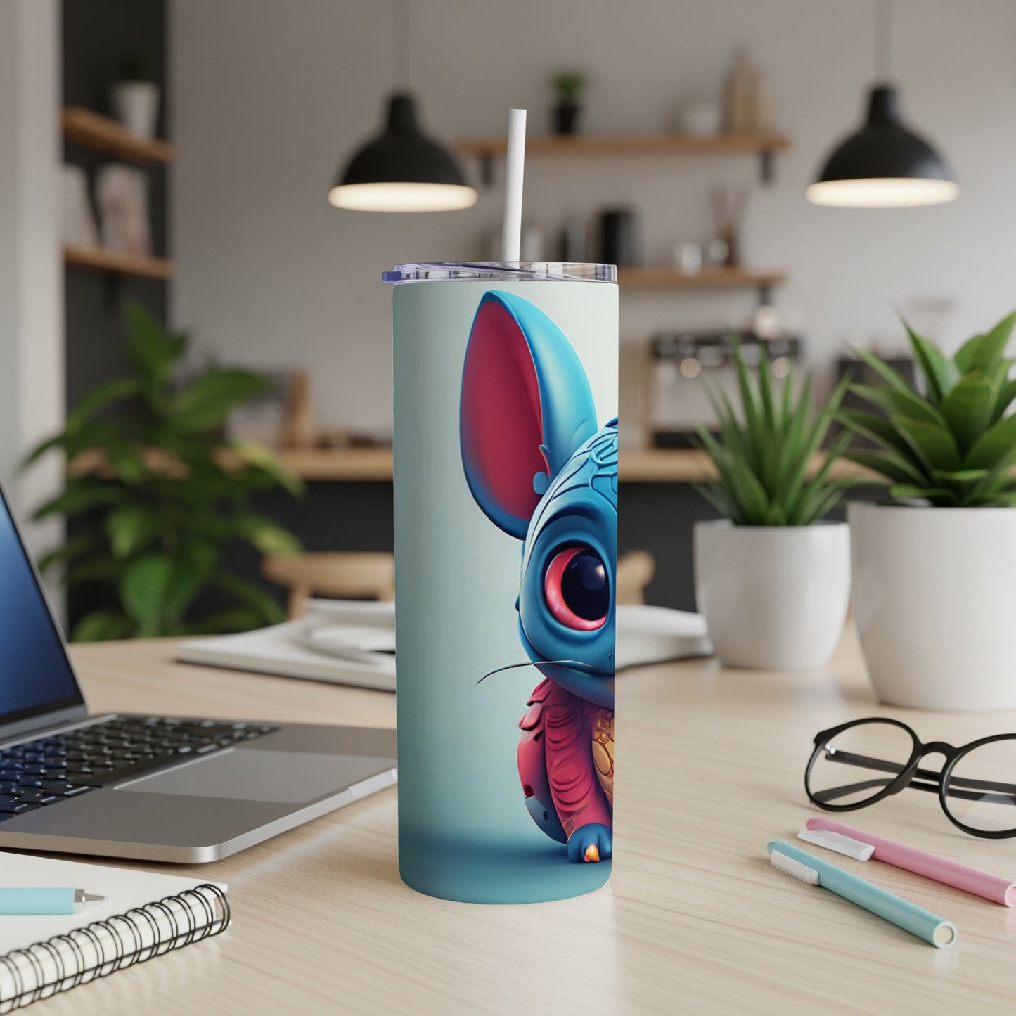 Cute blue creature with large eyes on a white tumbler with straw.