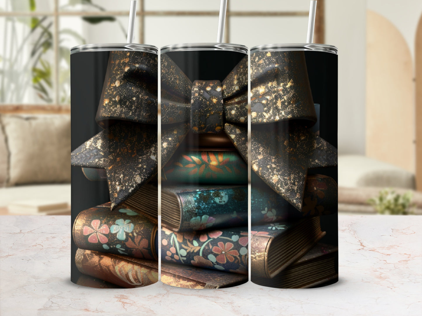 Three tumblers decorated with stacked books and a sparkly bow.