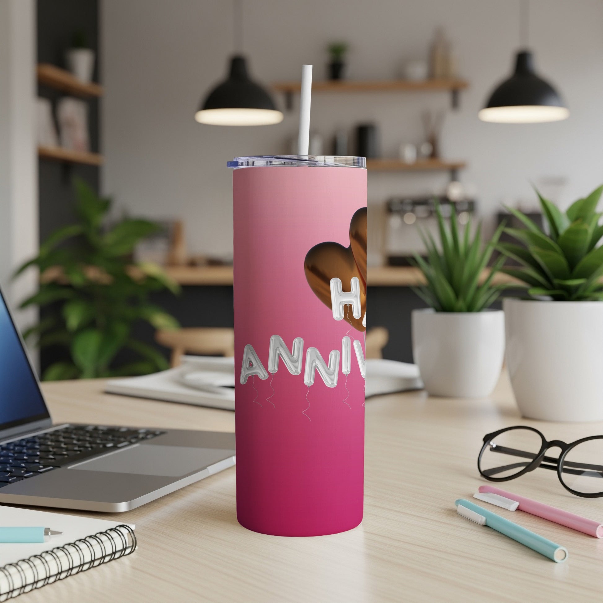 Pink tumbler with "Happy Anniversary" text and heart design.