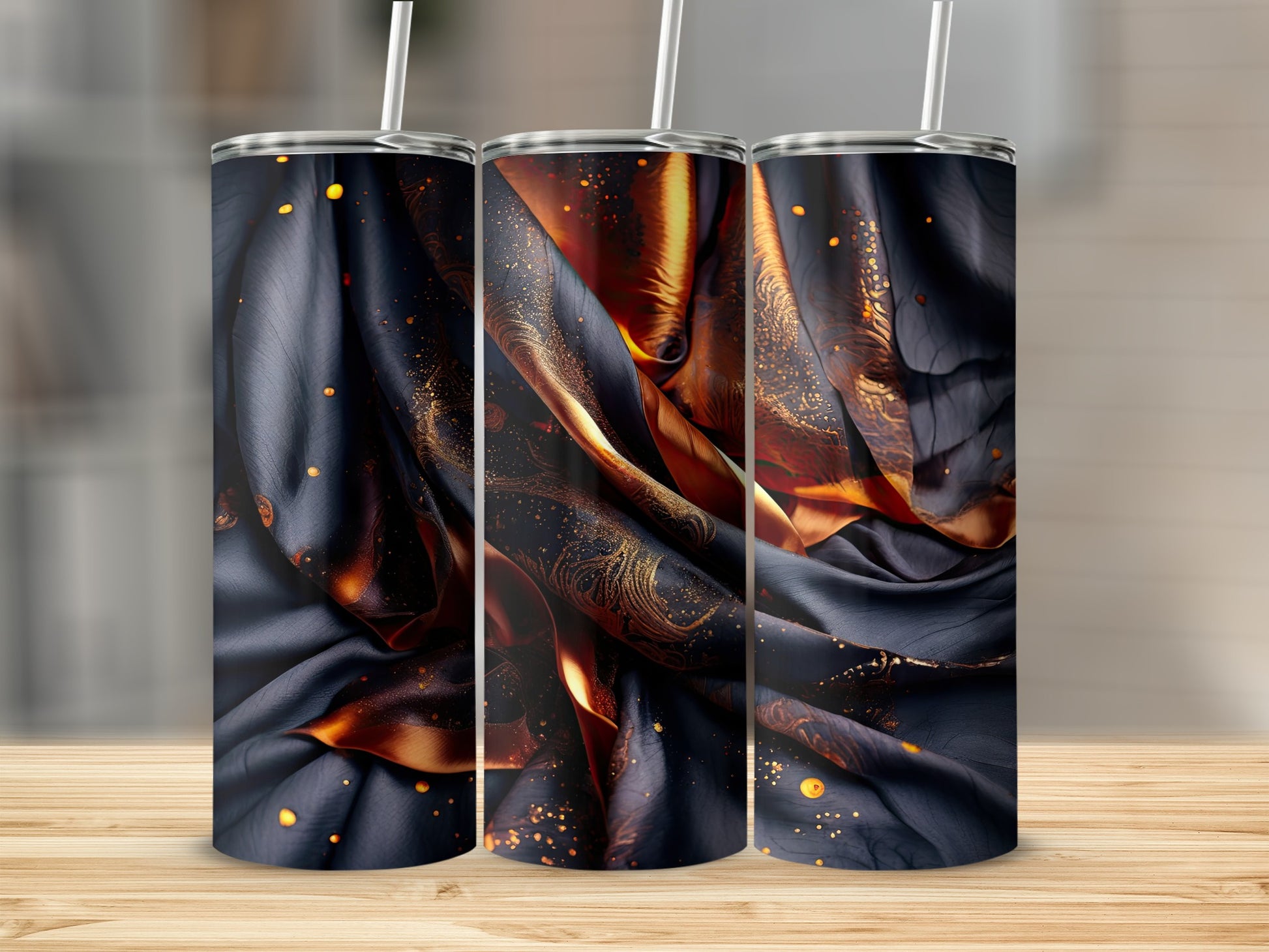 Dark fabric with gold swirls and speckles on three tumblers.
