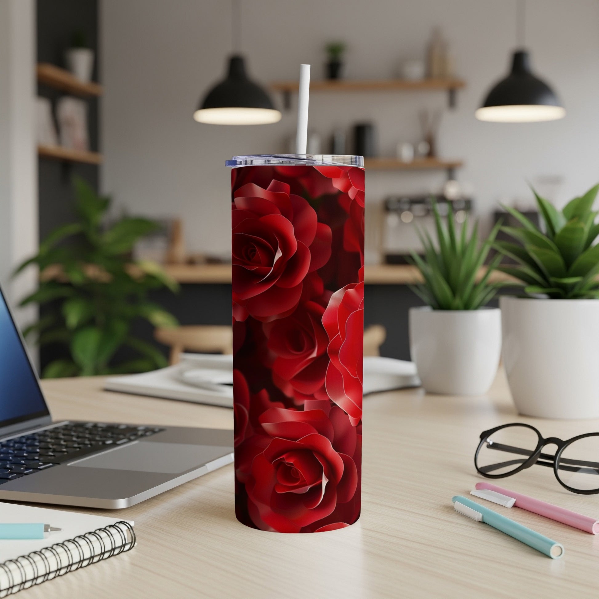 Red roses pattern on a skinny tumbler with a white straw.