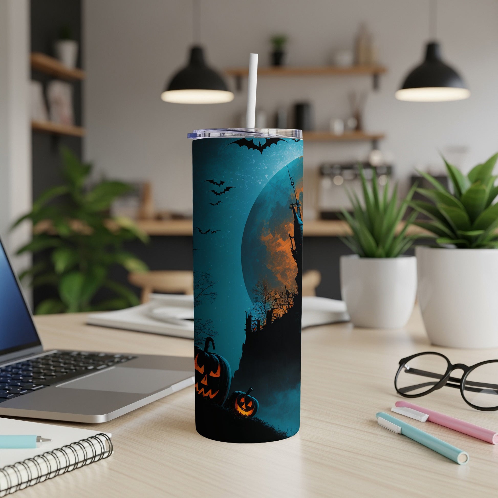 Halloween tumbler with a castle, moon, bats, and jack-o'-lanterns on a dark blue background.