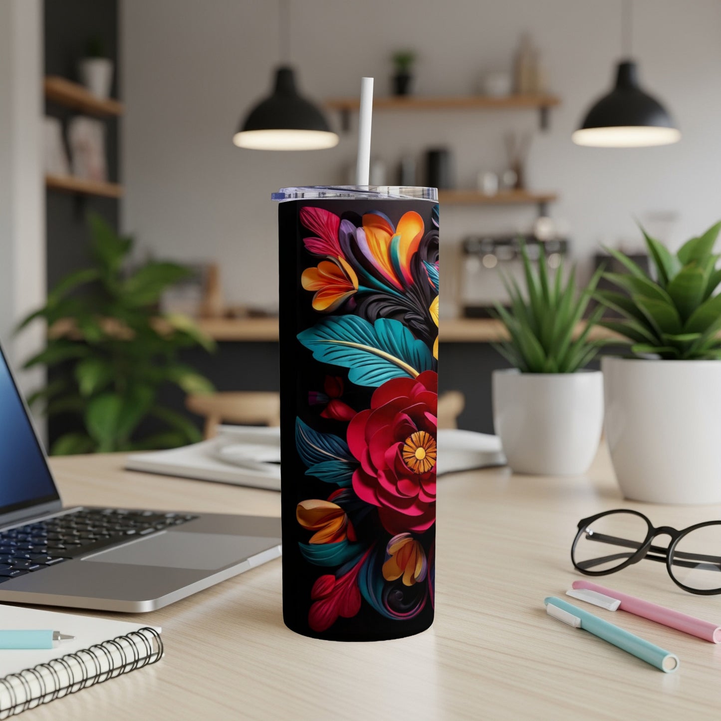 Tall tumbler with colorful floral design on black background.