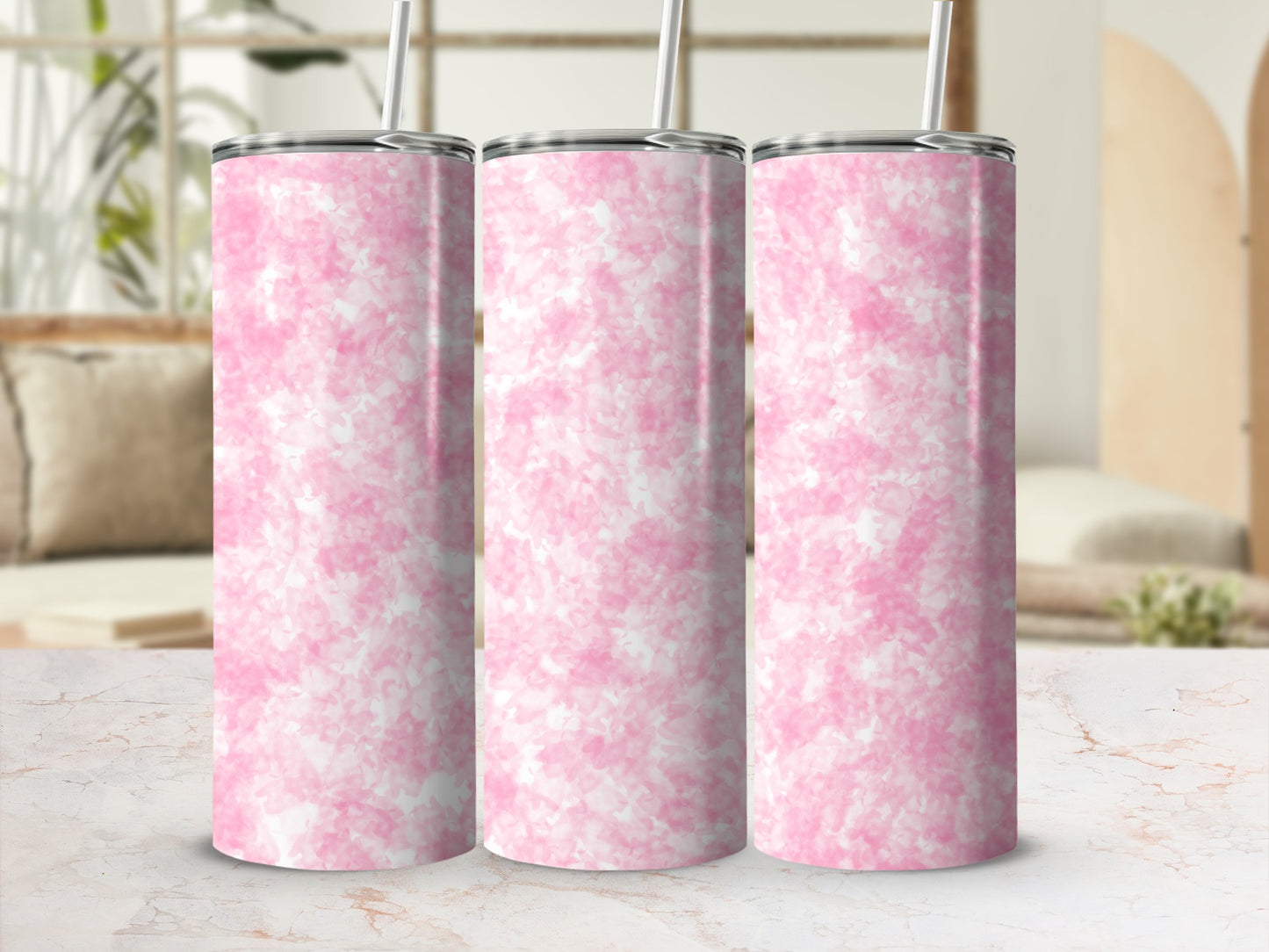 Three pink marble pattern tumblers with straws on a marble surface.