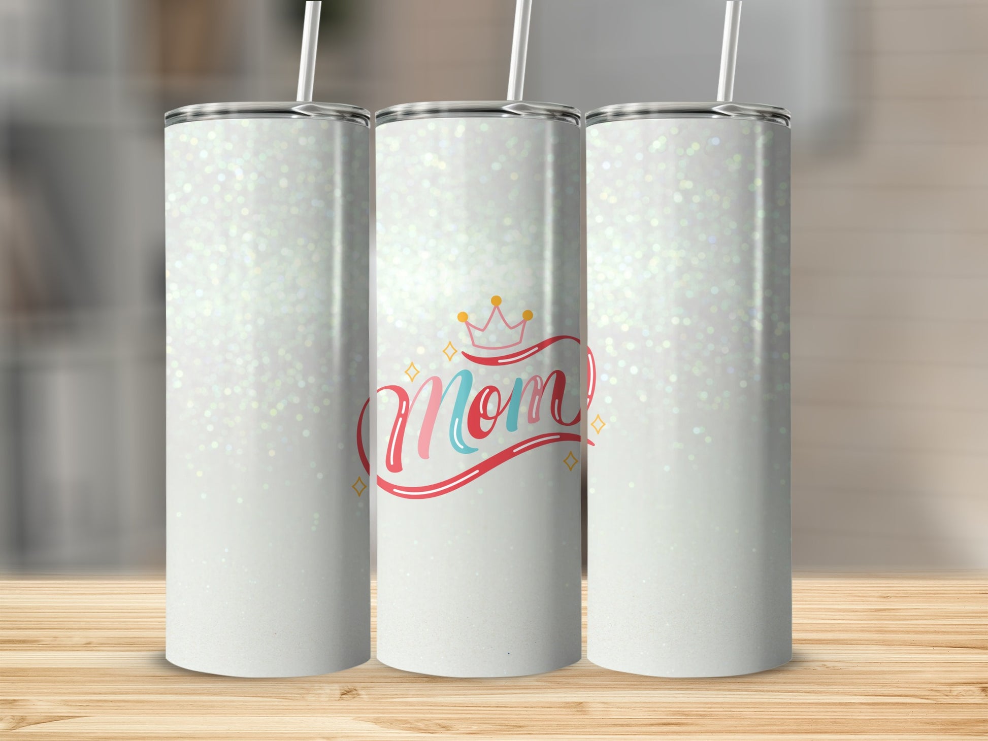 Glittery white tumblers with "Mom" text and crown graphic.