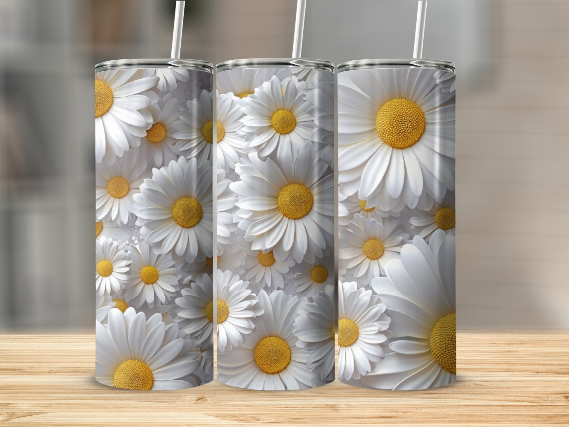 Three tumblers with a repeating pattern of white daisies and yellow centers.
