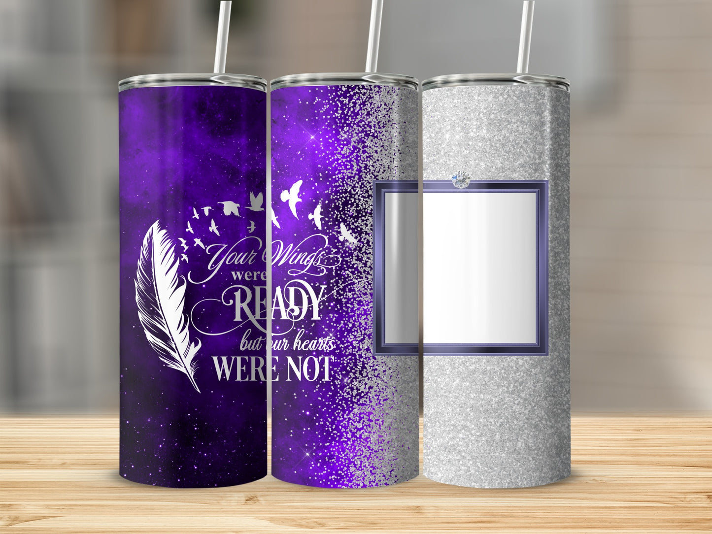Three tumblers with purple and silver glitter, one with feather and bird graphic.