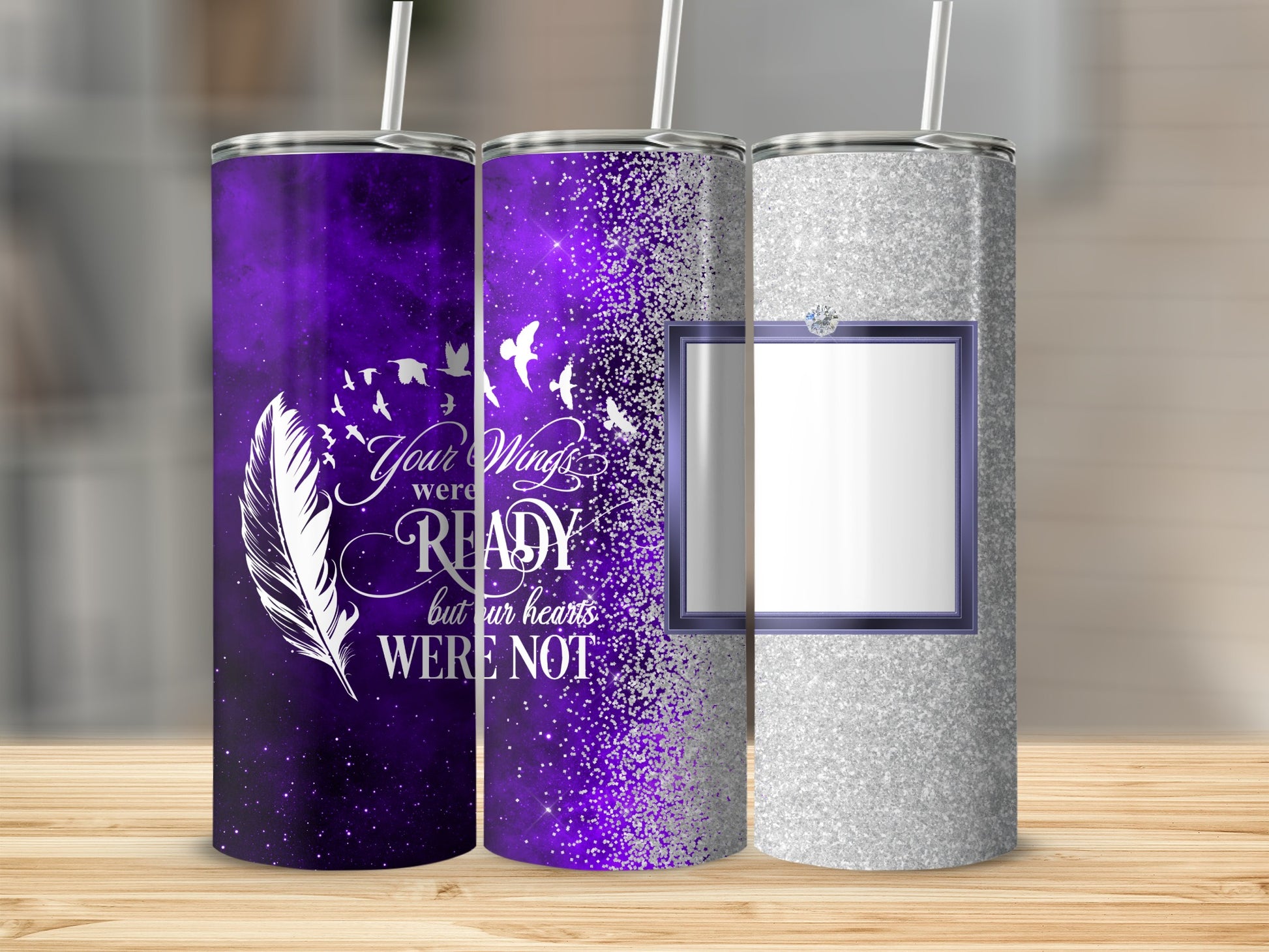 Three tumblers with purple and silver glitter, one with feather and bird graphic.