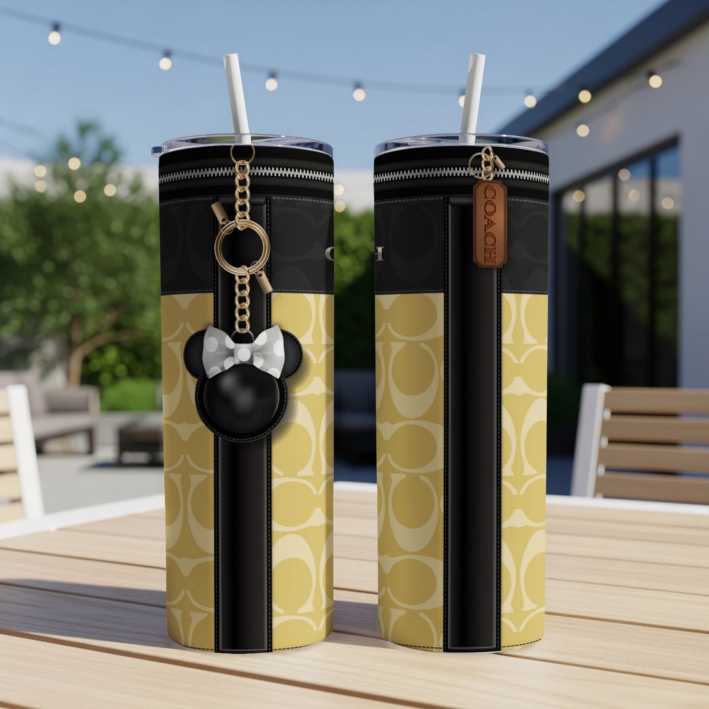 Two tumblers with Coach C pattern, featuring a Mickey Mouse charm and Coach tag.