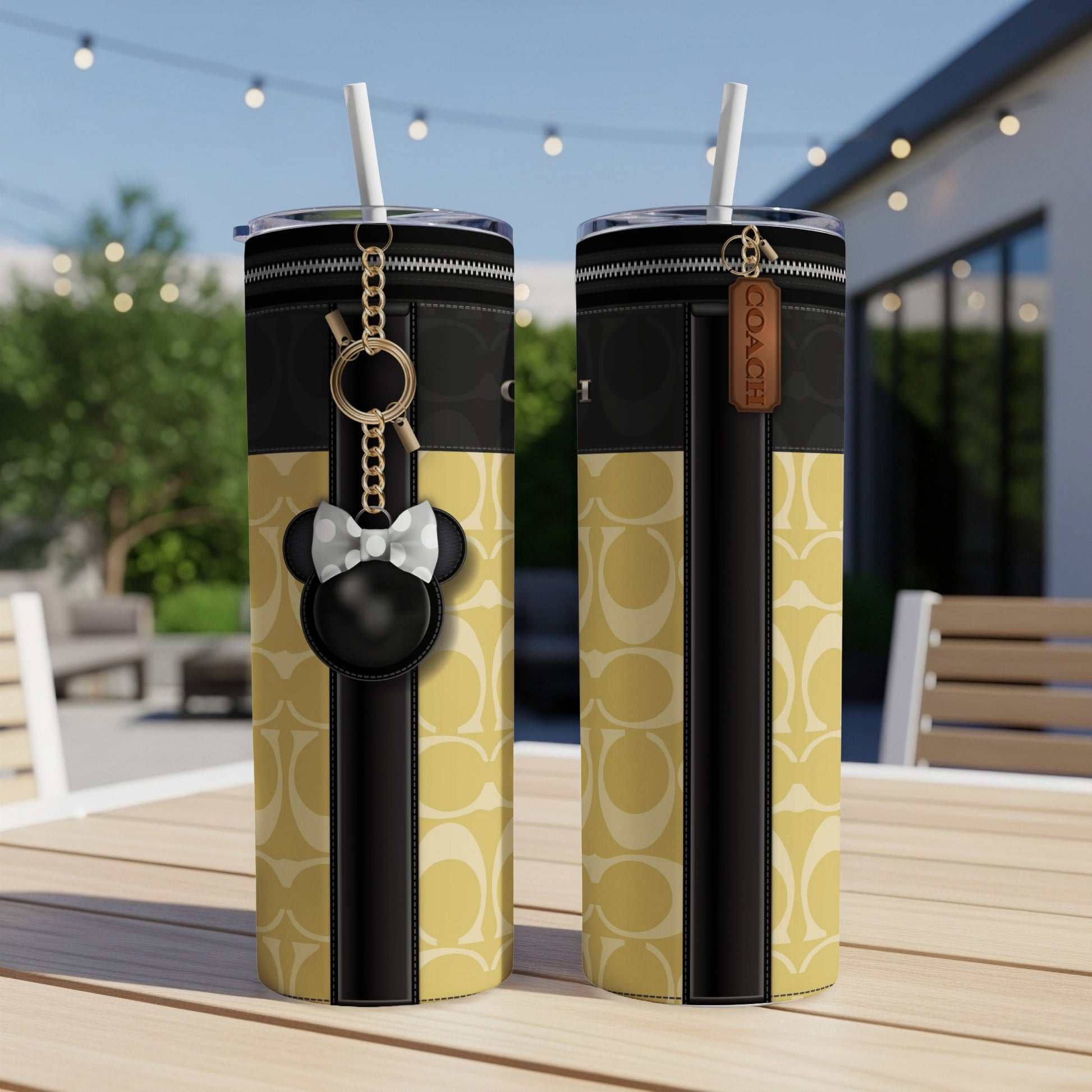 Two tumblers with Coach C pattern, featuring a Mickey Mouse charm and Coach tag.