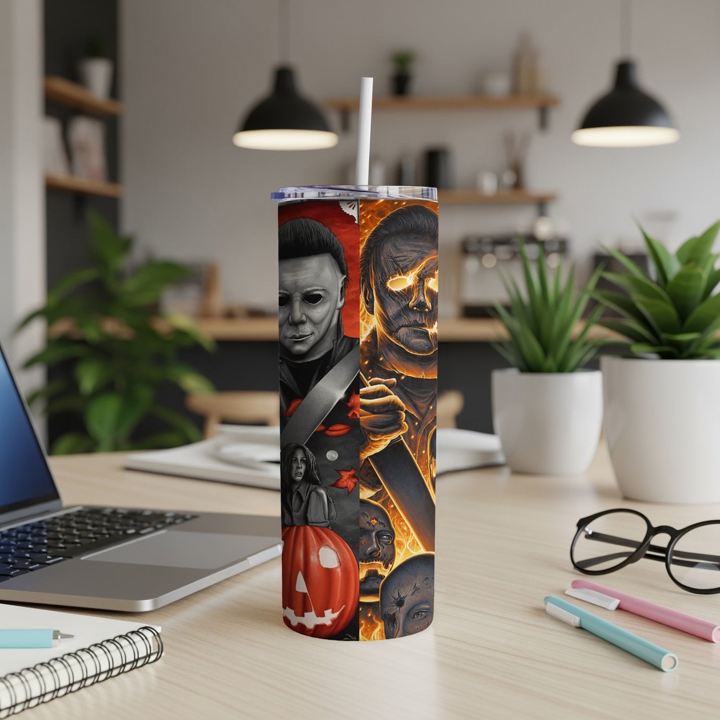 Michael Myers and flaming skull artwork on a Halloween-themed tumbler.