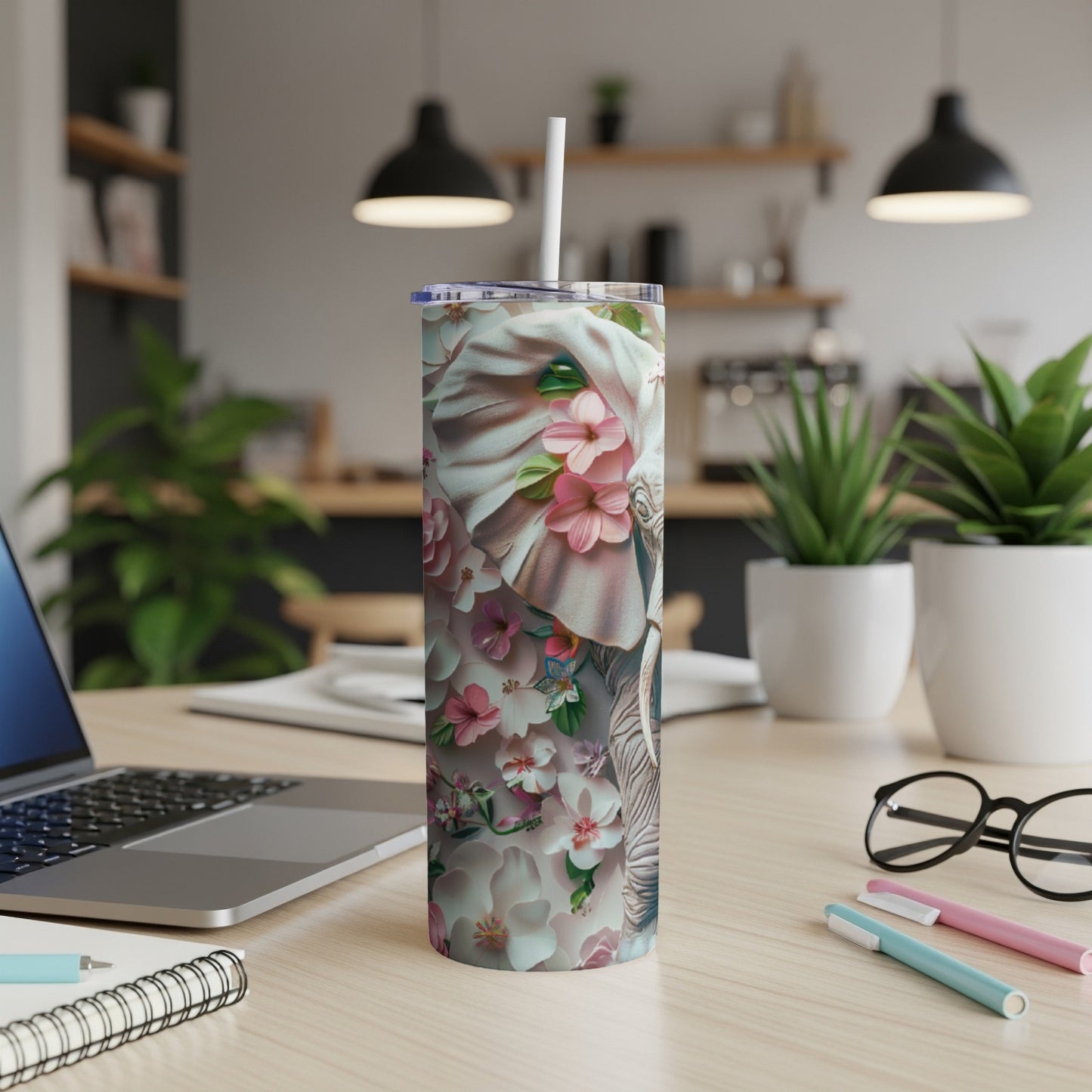 Tumbler with floral elephant design and white straw.