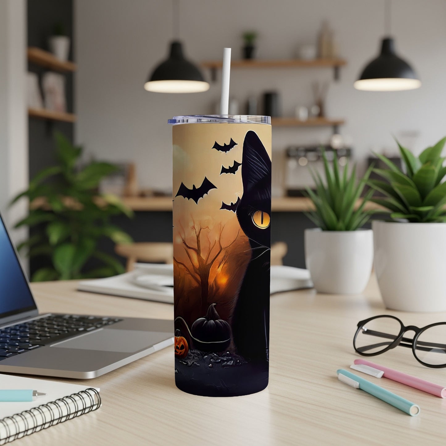 Tumbler with black cat, pumpkins, and bats against a Halloween scene.
