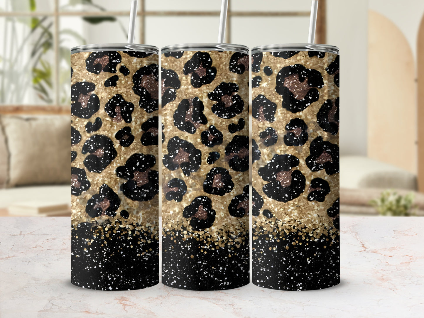Three tumblers with leopard print and gold glitter designs.
