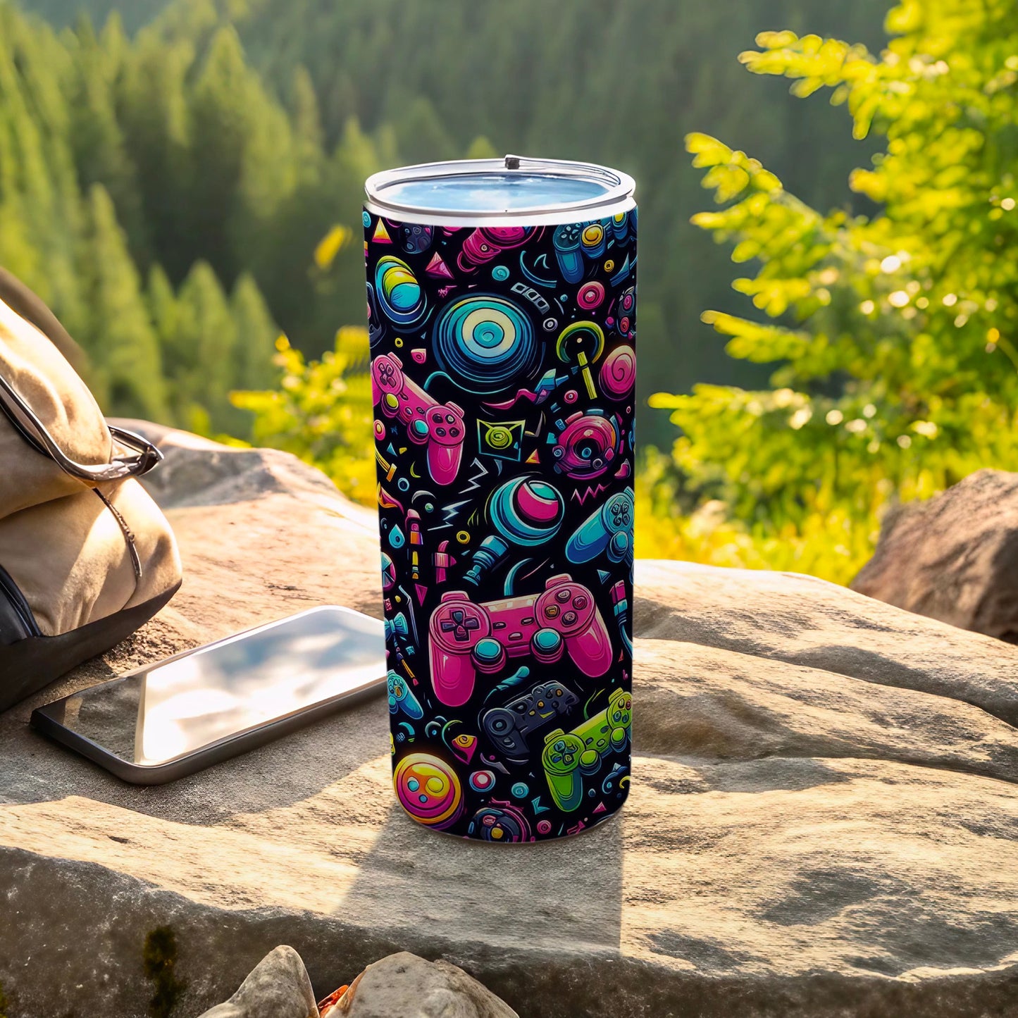 Tall tumbler with colorful video game controllers and icons on textured surface.