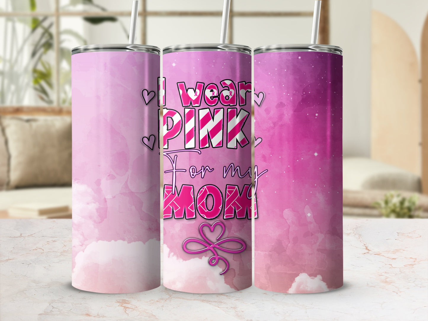 Pink tumbler with "I wear pink for my mom" text and cloud pattern.