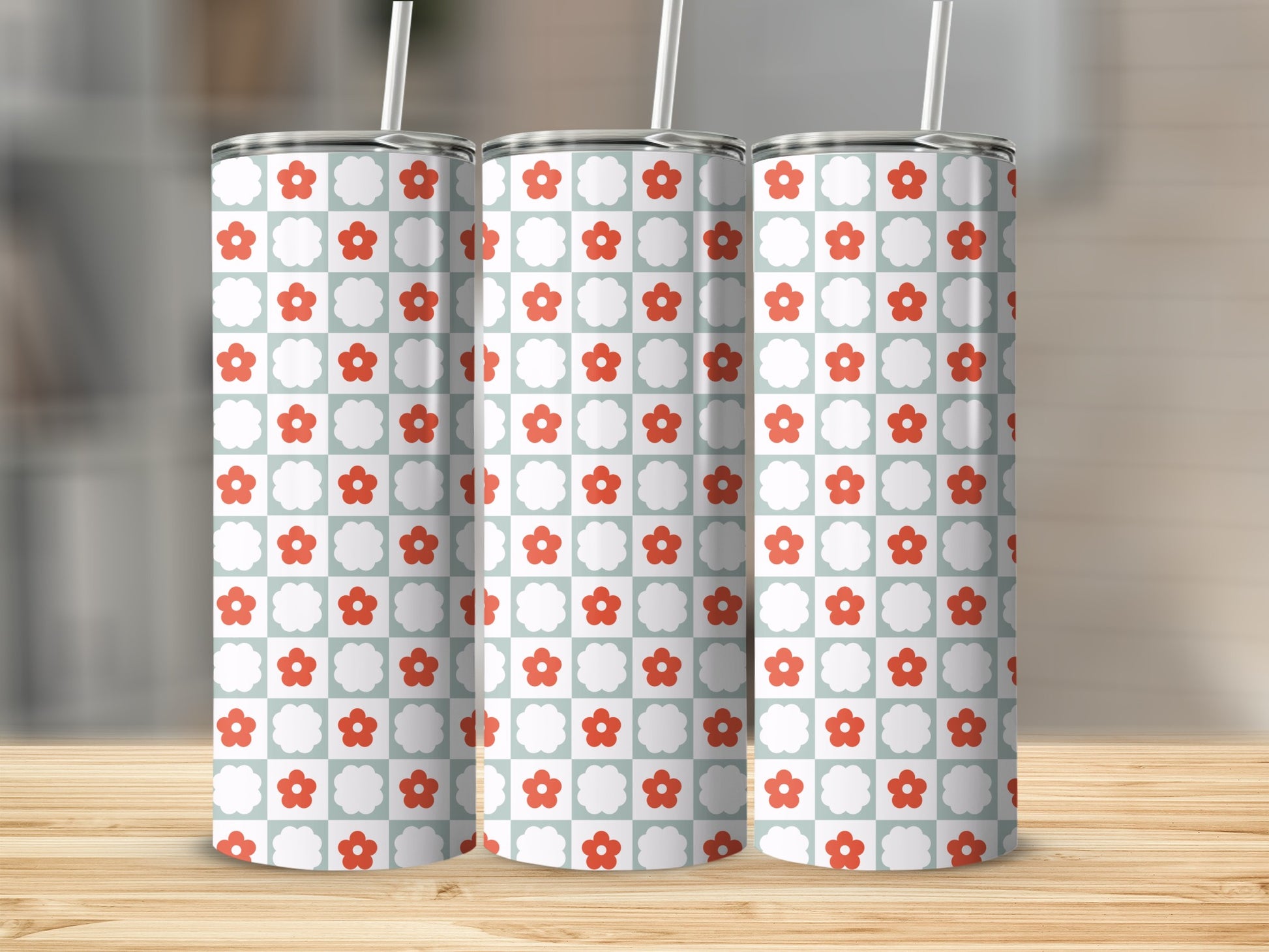 Three tumblers with a red and white flower pattern on a checkered background.