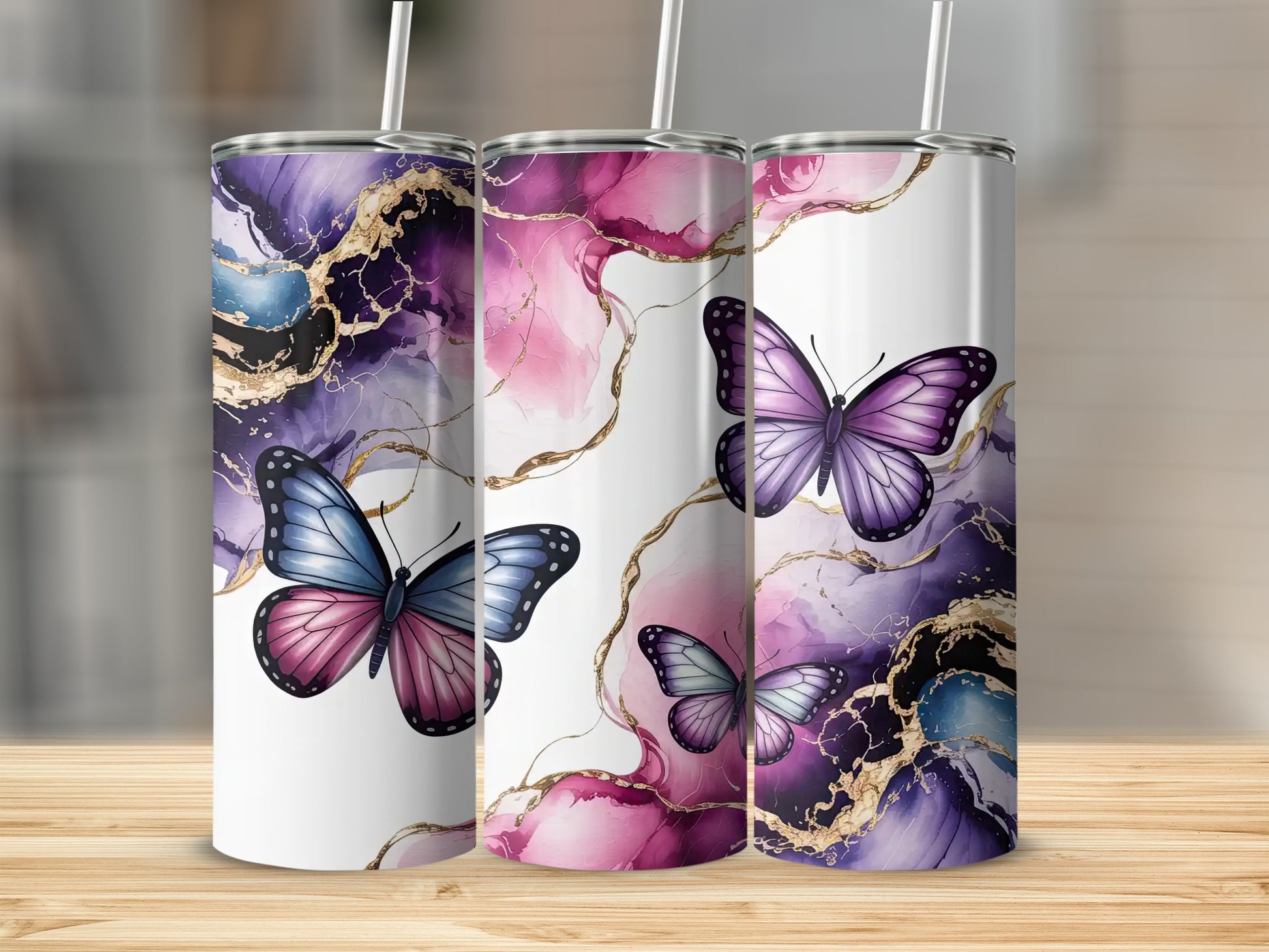 Three tumblers with purple and pink marbled patterns and butterflies.