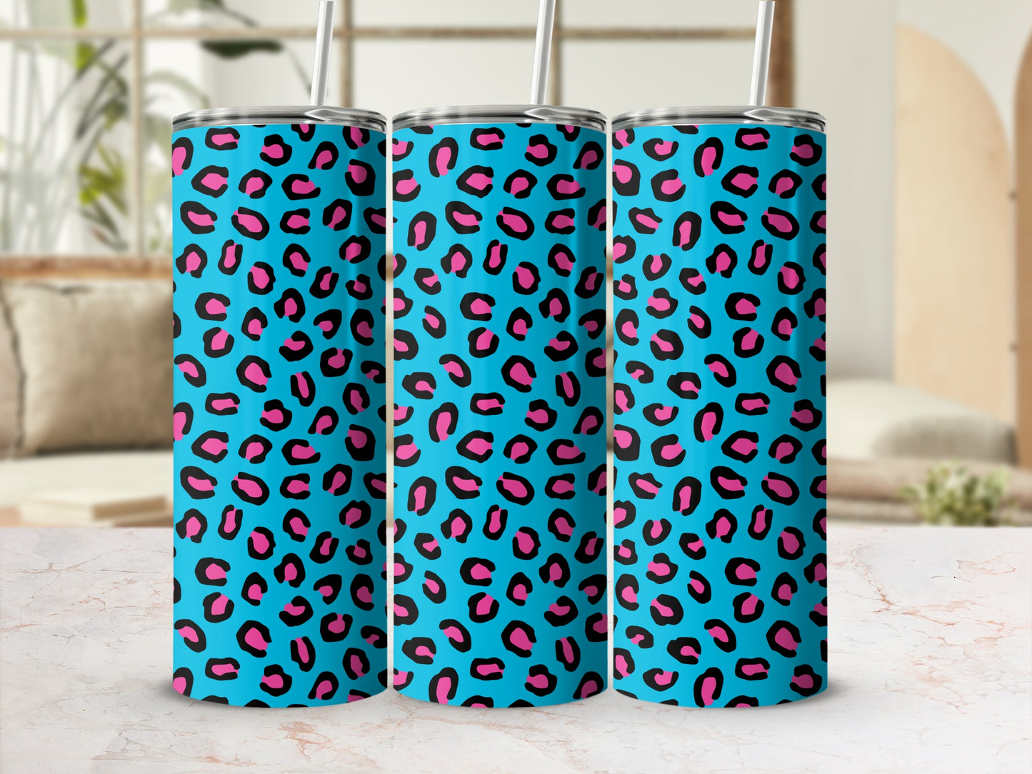 Three tumblers with a bright blue background and a black and pink leopard print pattern.