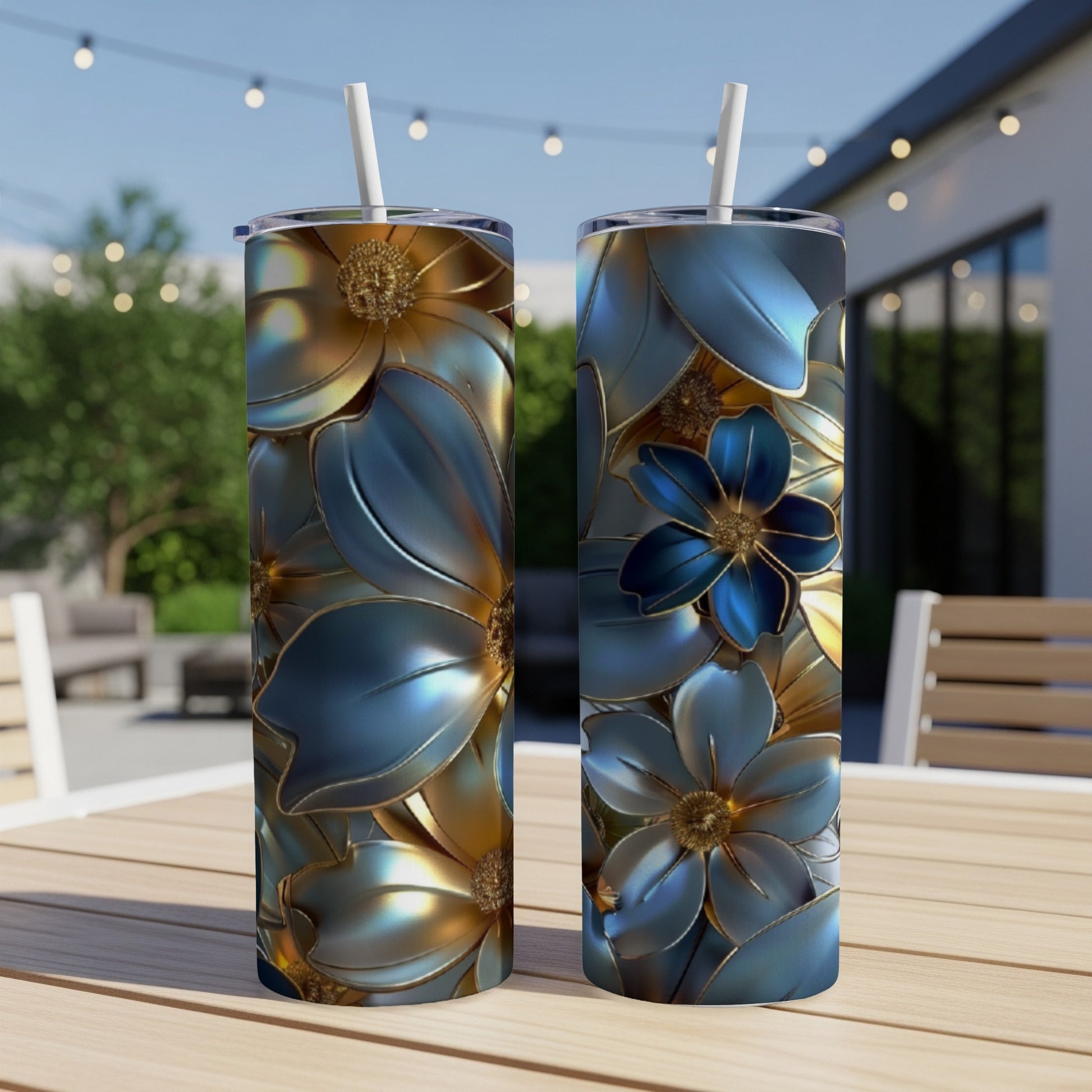 Two blue and gold metallic floral print tumblers on a wooden table.