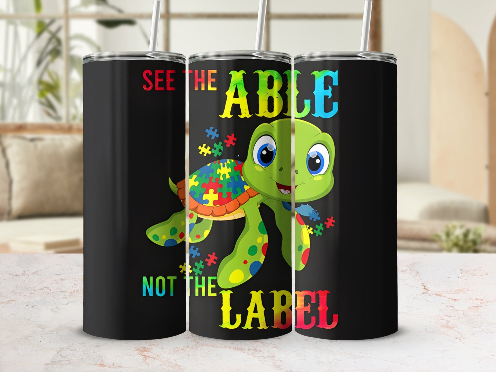 Black tumbler with turtle graphic and "See the Able, Not the Label" text.