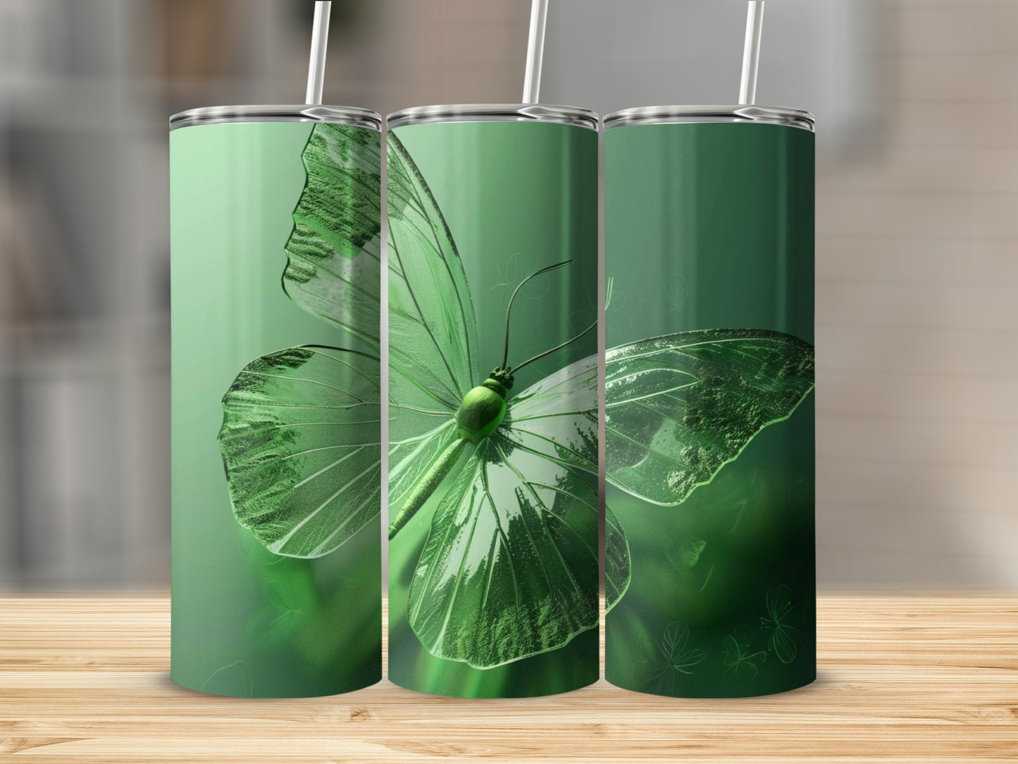 Green butterfly illustration on three cylindrical tumblers.