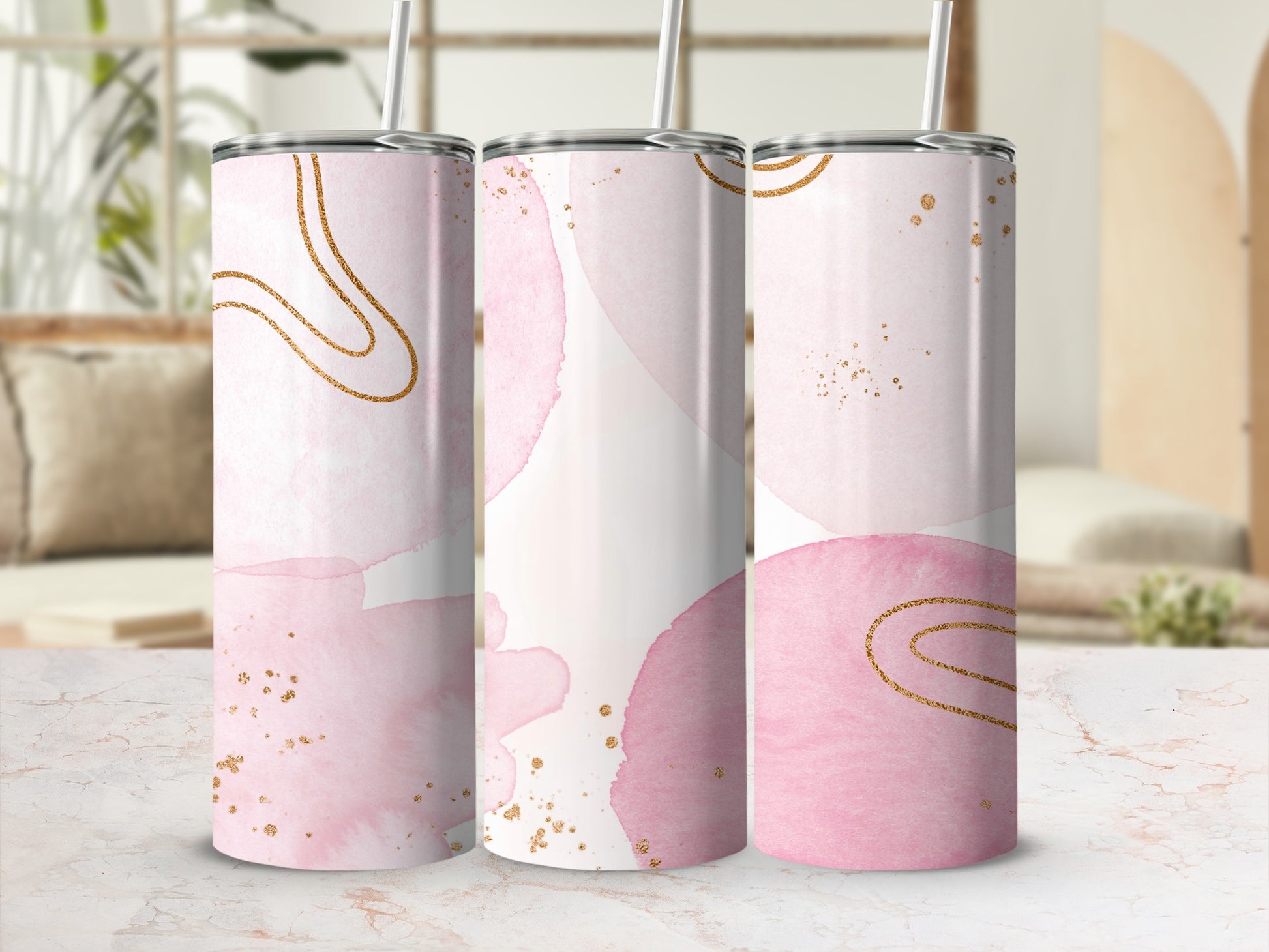 Three pink watercolor tumblers with gold accents and straws.