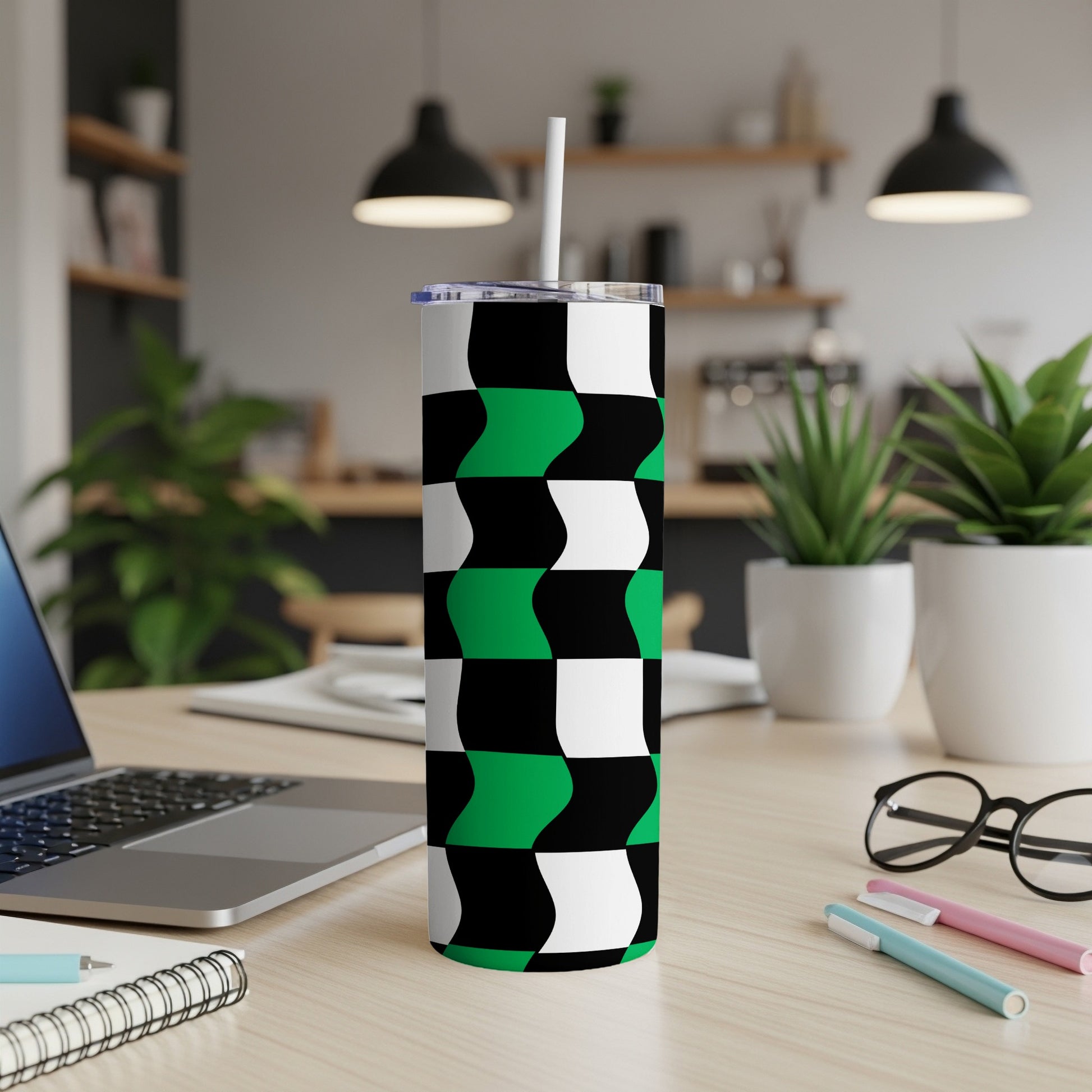 Tumbler with black, white, and green wavy checkered pattern.