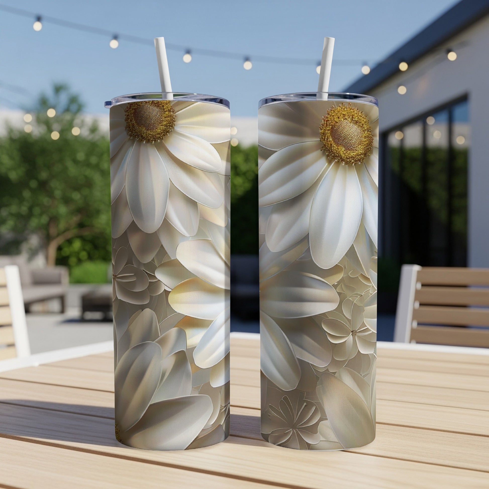 Two white daisy tumblers with straw on a wooden table.