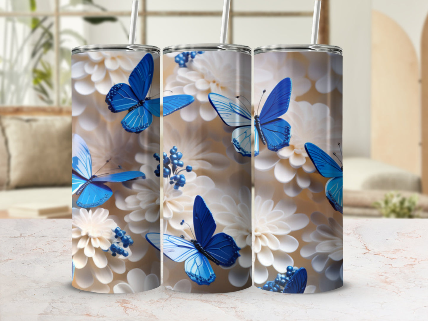 Three tumblers with blue butterflies and white flowers.