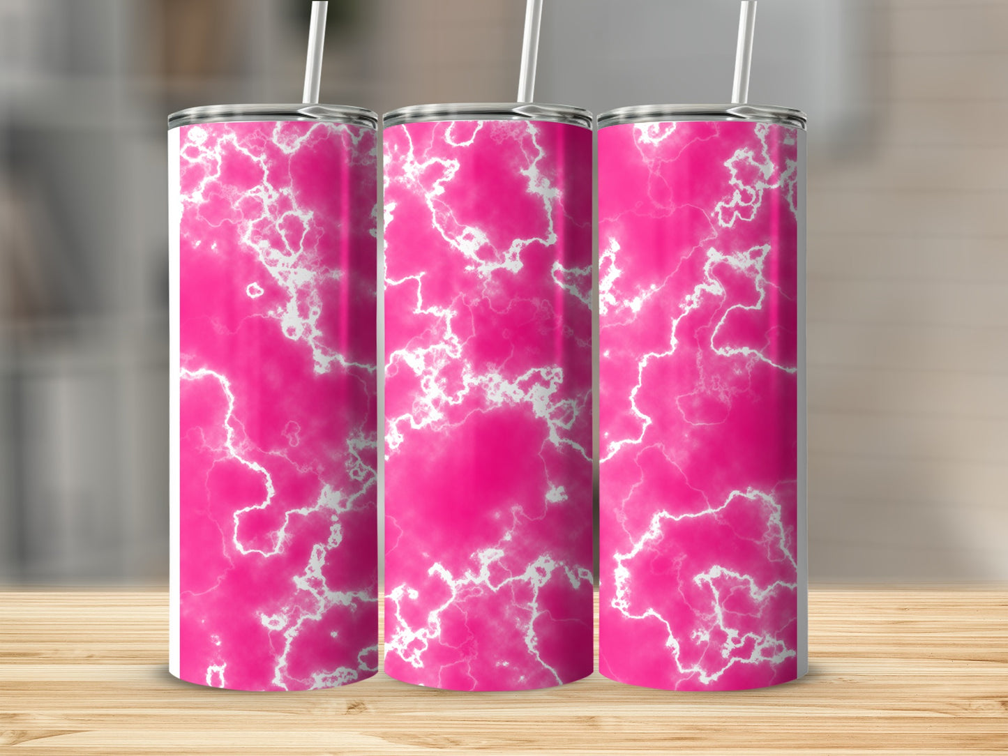 Three pink marble pattern tumblers on a wooden surface.