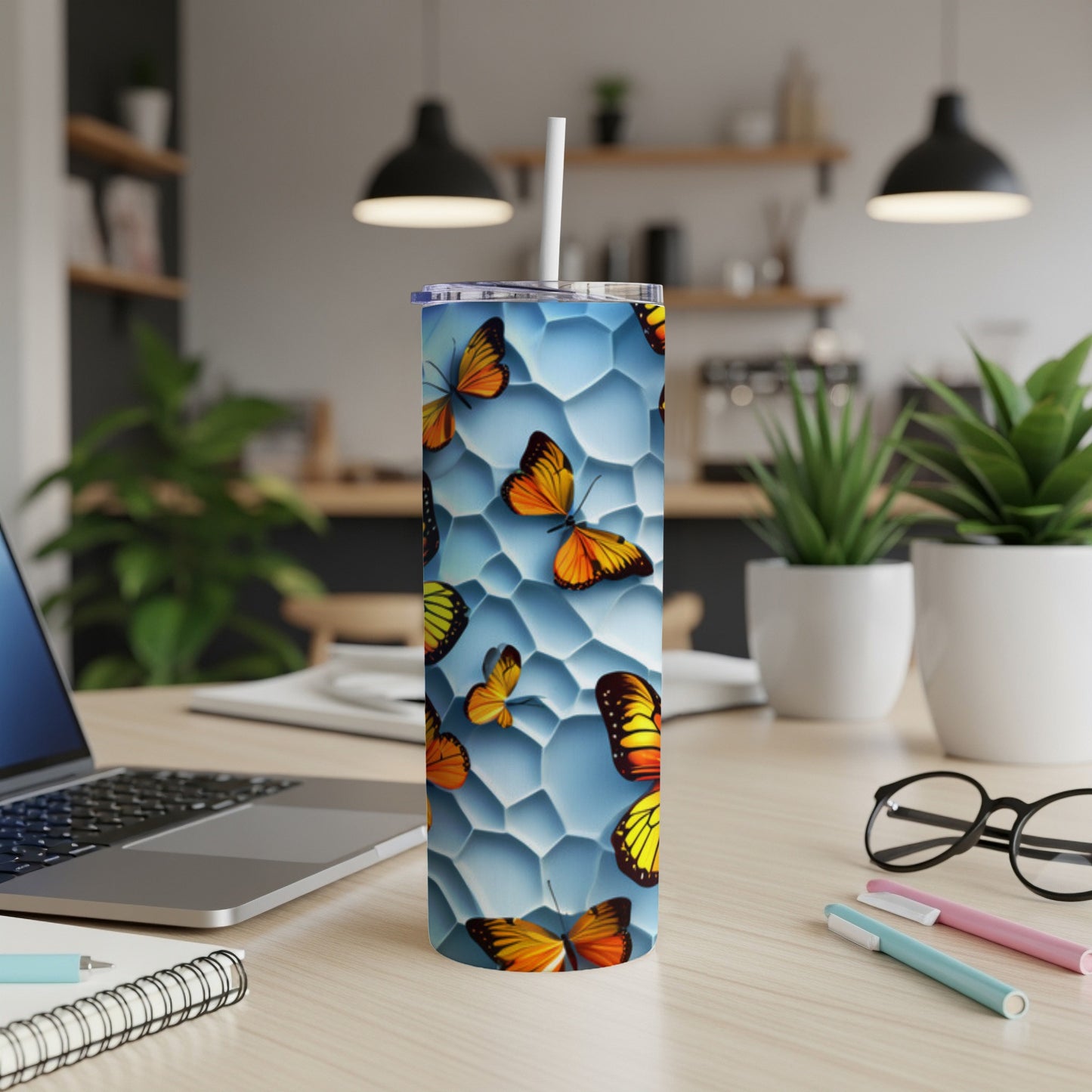 Blue hexagon pattern tumbler with colorful butterflies, straw.