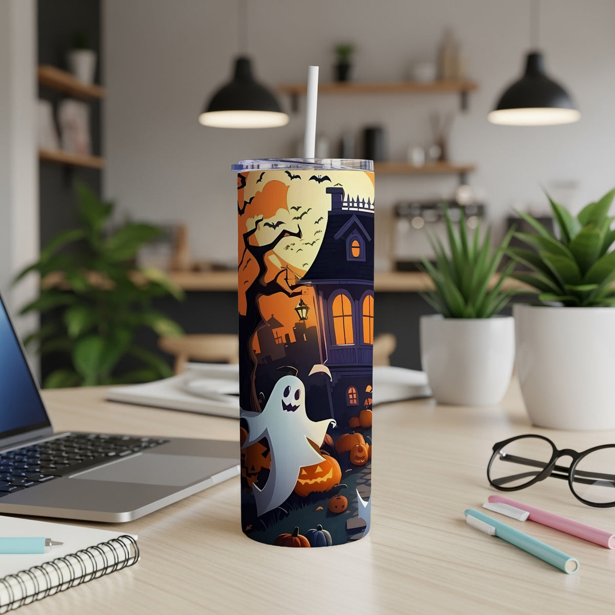 Halloween tumbler with ghost, haunted house, pumpkins, and bats on a warm background.