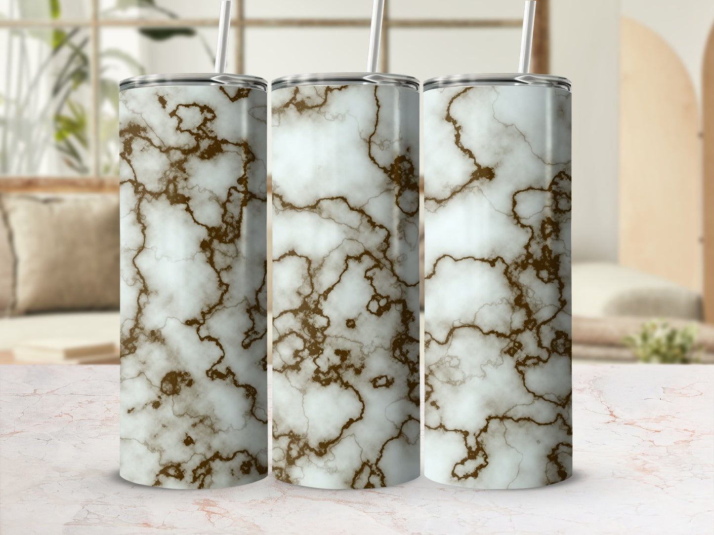 Three tumblers with white and brown marble pattern and straws.
